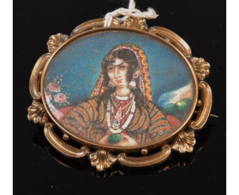 A circa 1900 Indian school portrait miniature watercolour on ivory and in yellow metal mount, unmarked but tests as 14ct, wid