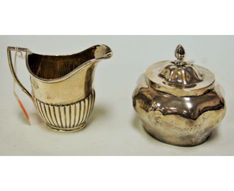 An Edwardian silver sucrere and cover, Birmingham 1904; together with a George V silver cream jug by William Hutton & Son, Sh