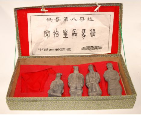 A boxed set of four ceramic figures, each modelled as soldiers from the Chinese Terracotta Army (lacking horse)