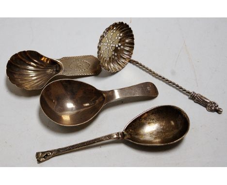 An early 19th century silver caddy spoon and one other similar of the period; together with a Continental silver jam spoon; a