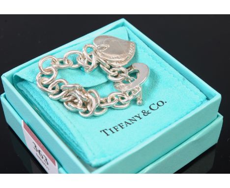 A Tiffany & Co. sterling silver bracelet with heart shaped pendants in original box and pouch