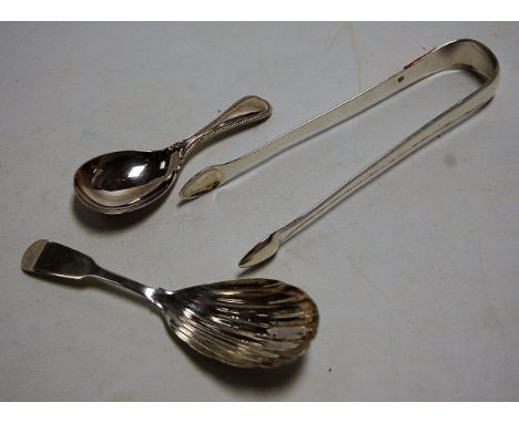 A William IV Irish silver caddy spoon, with shell shaped bowl; one other later example by Walker & Hall; together with a pair