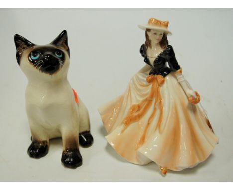 A Royal Worcester figurine 'Caroline'; together with a Wynstanley pottery cat (2) 