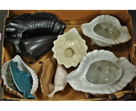 A collection of conch shell table ornaments, to include Poole Pottery examples 
