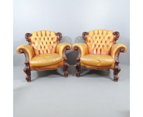 A pair of 19th century continental oak and button-back studded leather upholstered baroque armchairs with carved decoration. 