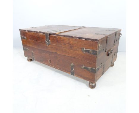An oriental metal bound hardwood trunk, with three lifting lids revealing internal compartments and single drawer to front. 1