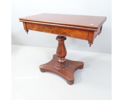 A 19th century mahogany fold-over tea table, raised on turned central column with platform base. Interior compartment has bee