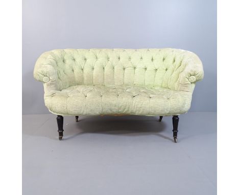 An early 20th century button-back upholstered loveseat or two-seater sofa, raised on turned ebonised legs. Overall 135x77x90c