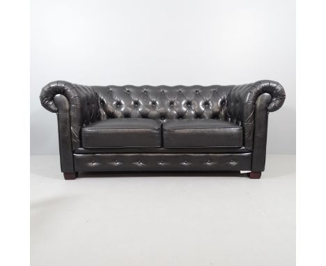 A two-seater black button-back leather upholstered Chesterfield style sofa. Overall 188x80x90cm. Seat 120x43x58cm. 