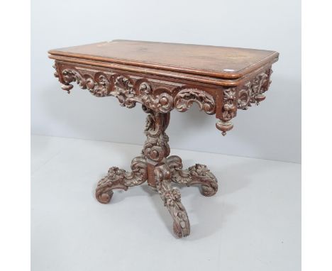 A 19th century carved oak fold-over card table, raised on central column with platform base. 89x78x45cm.Some water damage, fe
