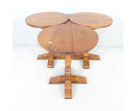 A set of three oak circular lamp / occasional tables. 46x57cm. 