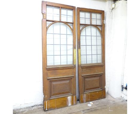 A pair of antique mahogany pub saloon doors, with leadlight glazed panels and brass finger plates. Each 76x228x10cm. 
