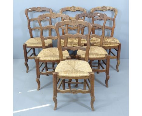 A set of six French oak ladder back dining chairs, with rush seats. 