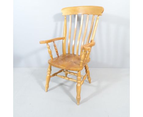 A light oak Windsor kitchen armchair. 