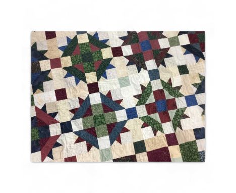 NORTH AMERICAN PATCHWORK QUILT, EARLY 20TH CENTURY  with various geometric designs, on a red ground243cm long Condition overa