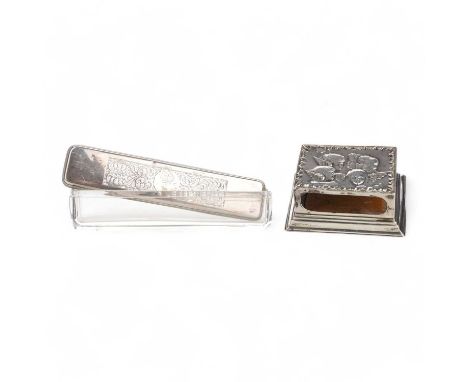 SILVER TABLE MATCHBOX HOLDER, AND SILVER TOPPED GLASS TOILET BOTTLE the matchbox case embossed with winged cherubsthe matchbo