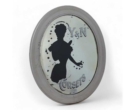 Y & N CORSETS, ADVERTISING MIRROR, LATE 19TH / EARLY 20TH CENTURY bevelled oval plate with painted inscription and silhouette