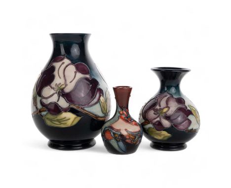 MOORCROFT, COLLECTION OF THREE VASES, two in the Magnolia pattern, the other in the red tulip pattern, all bearing Moorcroft 