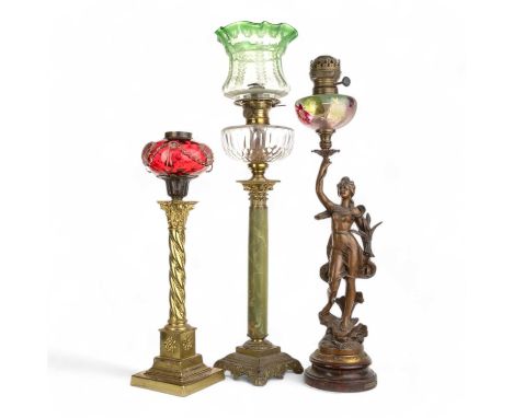 THREE VICTORIAN OIL LAMPS, LATE 19TH CENTURY comprising one brass and onyx, one cranberry glass and brass and one bronzed spe