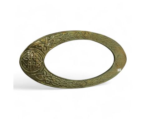 BRASS ARTS & CRAFTS WALL MIRROR, of oval form, with Celtic knot decoration82cm wideCondition good to fair. Subject to typical