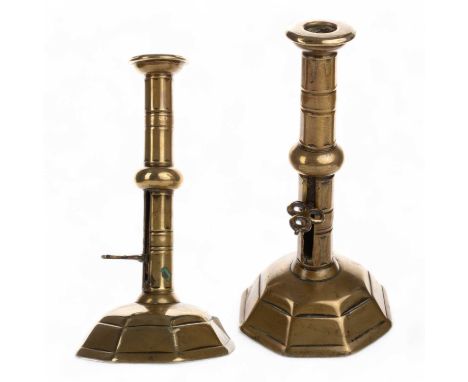 PAIR OF QUEEN ANNE BRASS EJECTOR CANDLESTICKS, with cannon barrel stem, trefoil pierced ejector, on a domed octagonal base20c