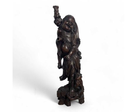 JAPANESE HARDWOOD FIGURE, LATE 19TH CENTURY  of large proportions, modelled as a man with a mythical creature, raised on a st