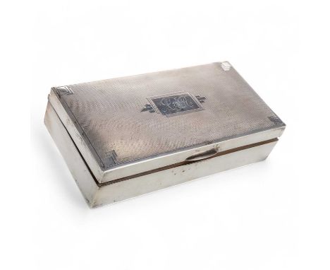 GEORGE V ART DECO SILVER CIGARETTE CASKET, of rectangular form, the hinged lid with engine turned decoration17cm wide