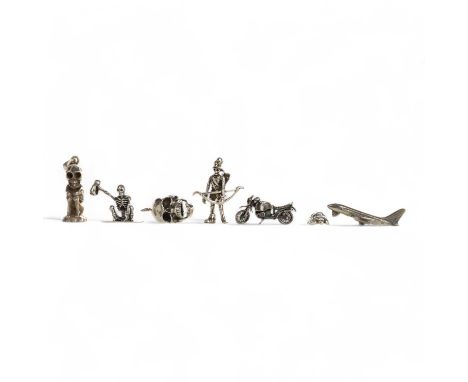 COLLECTION OF SILVER AND WHITE METAL MINIATURES, comprising eighteen skull or skeleton pendants, a sea turtle, a motorbike, a