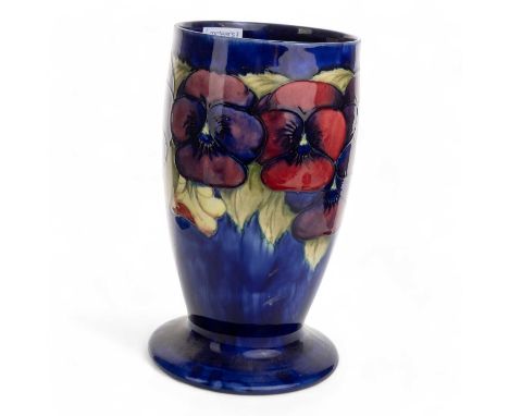 MOORCROFT VASE, pansies pattern wth tube lined stylised floral decoration on blue ground27cm highCondition overall is good to