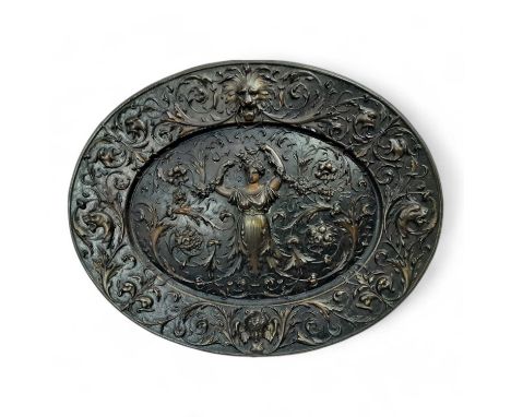 VICTORIAN CAST IRON PLAQUE, of oval form, depicting a figure, Green Man and puti, surrounded by scrolls maker Gowanbank found