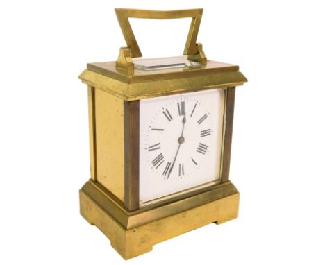 A 20thC brass cased carriage clock, the white square enamel dial bearing Roman numerals, key wind, 14.5cm high, with key.
