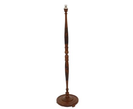 An Oriental carved hardwood standard lamp, decorated with figures, pagoda, trees, etc., on a circular base, on block feet, 16