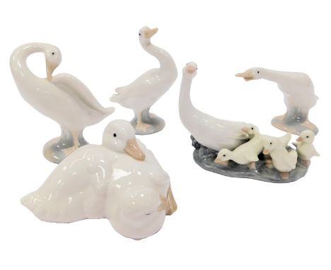 A group of Lladro and Nao porcelain, comprising three standing Lladro geese, a Nao duckling group, and a Lladro group compris