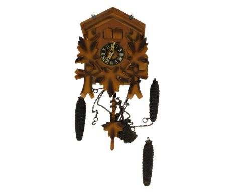 A 20thC pine cased cuckoo clock, with a carved leaf decoration, Redula movement, weights and pendulum, 25cm high.