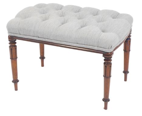 A 19thC mahogany footstool, with overstuffed button upholstered top, raised on cylindrical legs with lappet decoration, 44cm 