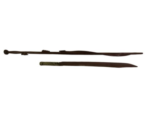 A Melanesian stick, carved with a head, serpent and a woodpecker, 101cm high, a knife, the handle bound with braided braia, 6