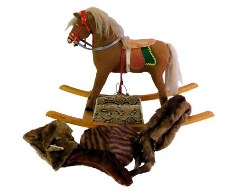 A 20thC rocking horse, with felt covering, on a wooden base, 60cm high, together with a snakeskin clutch bag and various furs