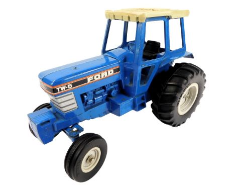 An Ertl Ford TW-5 toy tractor, in blue, 24cm high. 