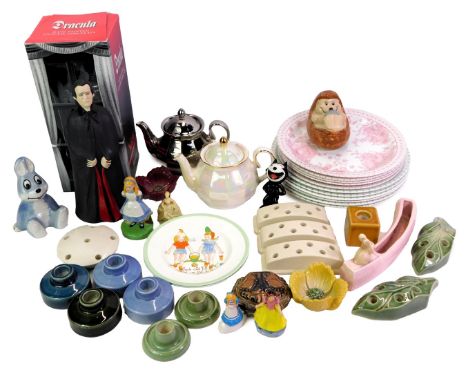 A group of Wade collectables, to include two anniversary teapots, a Dracula figure, Alice in Wonderland figure, plates, etc. 