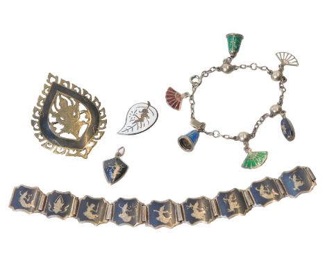 A Siamese silver and niello brooch, a nine-link silver and niello bracelet, on a snap clasp, a pair of silver and enamel leaf