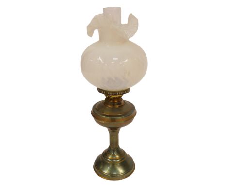 A 20thC brass oil lamp, with chimney, and a frilled, opalescent glass shade, 54cm high.