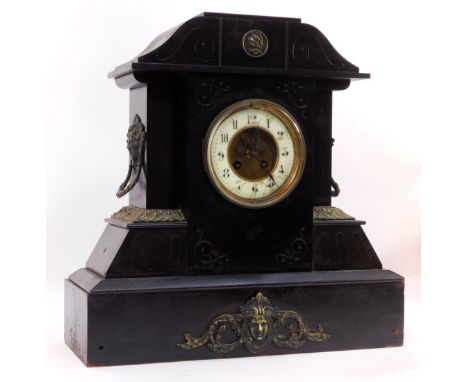 A Victorian black slate mantel clock, the circular white enamel dial bearing Arabic numerals, with visible brocot escapement,