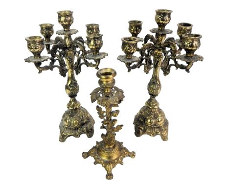 A pair of 20thC four branch candelabra, each cast with scrolls, etc., 32cm high, together with a single brass candlestick cas