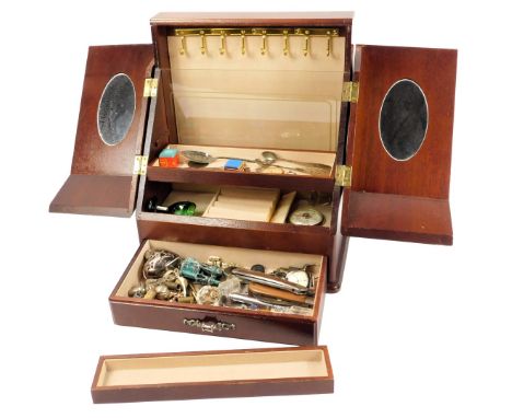 A 20thC mahogany jewellery box, two sloping hinged doors opening to enclose hooks for chains and sections for jewellery, the 