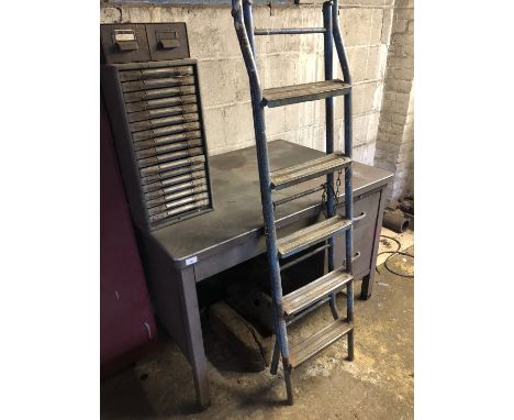 A steel desk, step ladder and filing drawers. (4)