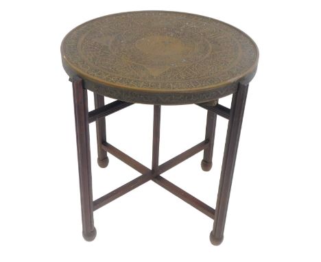 An early 20thC mahogany card table, the envelope top with green baize lining, on a circular base with brass border in the Eas