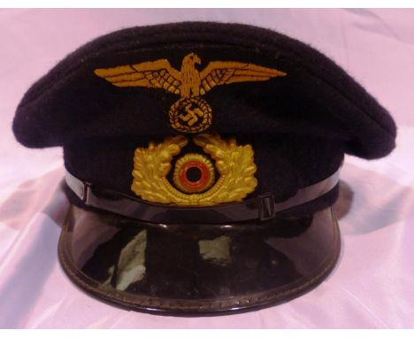 German WWII Kriegsmarine officers hat in black wool, with stitched gold eagle and pressed metal cockade, named inside LTND H 