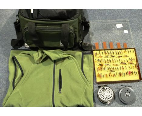 Ninety fishing flies and a Crane canvas bag containing reels etc. P&amp;P Group 2 (£18+VAT for the first lot and £3+VAT for s