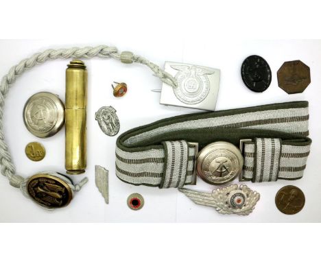 A quantity of Post War German and WWII replica uniform components, with a Trench Art lighter. P&amp;P Group 1 (£14+VAT for th