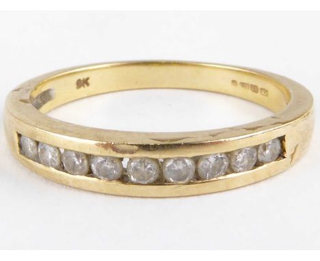 A 9ct gold half eternity ring with nine small channel set diamonds, size O, approx. 2.5g.